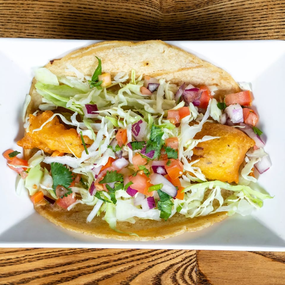 Fairweather's fish taco with crispy battered fish, shredded lettuce, and pico de gallo.