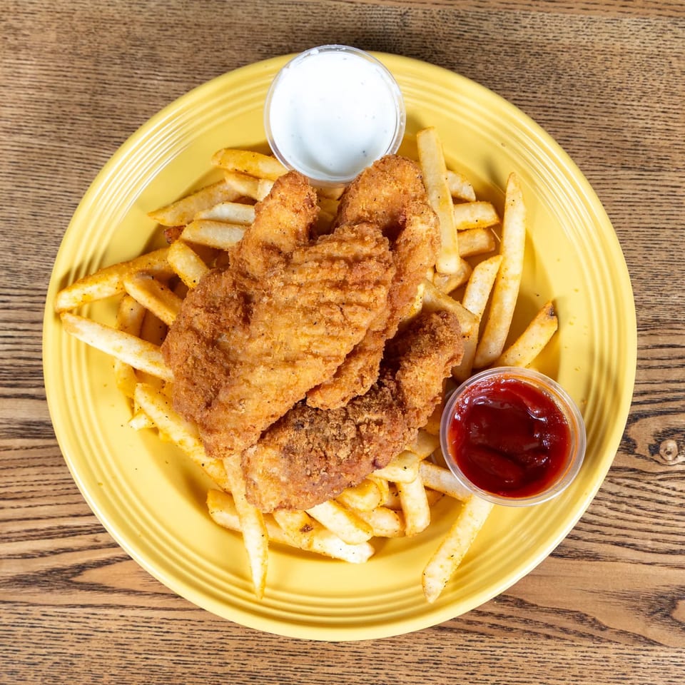 Fairweather's fried chicken tenders and french fries with ketchup and ranch on a yellow plate.